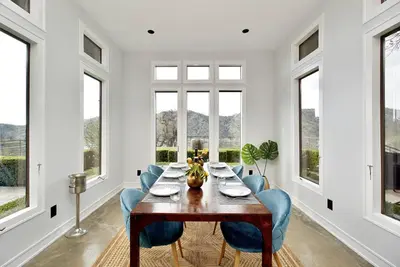 a dining room with a table and blue chairs at Serene Millerton Lake Villa w/ Panoramic Lake View