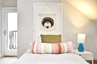 a bedroom with a white bed with a green pillow at Serene Millerton Lake Villa w/ Panoramic Lake View