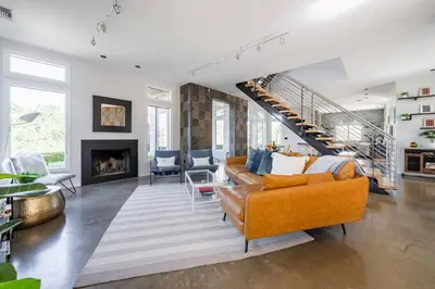 a living room with a couch and a staircase at Serene Millerton Lake Villa w/ Panoramic Lake View
