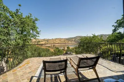 a patio with two chairs and a table on a deck at Serene Millerton Lake Villa w/ Panoramic Lake View