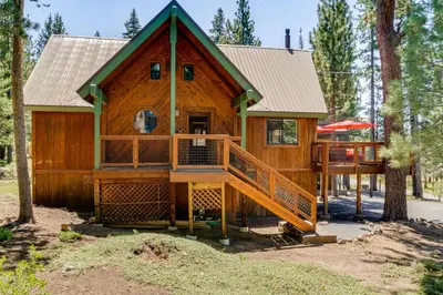 a cabin in the woods with a large deck at 1 Mi to Tahoe Donner Skiing Luxe Truckee Cabin! in Truckee