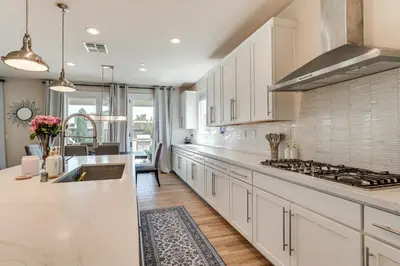 a kitchen with white cabinets and a counter top at Patio and Outdoor Kitchen Manteca Family Home in Manteca