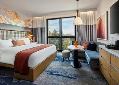 a hotel room with a bed and a couch at Limelight Mammoth in Mammoth Lakes