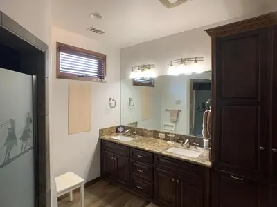 a bathroom with a sink and a large mirror at Ranch Resort Suite Near Sequoias in Woodlake