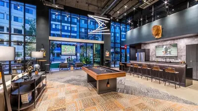 a lobby with a pool table in a building at Landing at RED in Reno