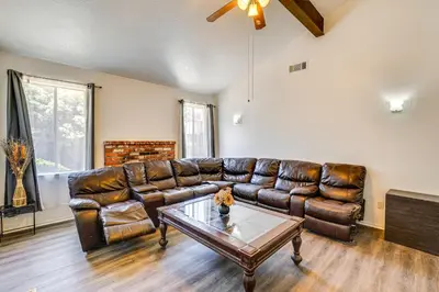 a living room with a leather couch and a coffee table at Updated Home in Suburbs - 10 Mi to Dtwn Stockton! in Stockton