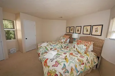 a bedroom with a bed with a colorful comforter at 2078 Traverse Court home in South Lake Tahoe
