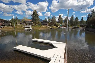 a dock in the middle of a body of water at 2078 Traverse Court home in South Lake Tahoe