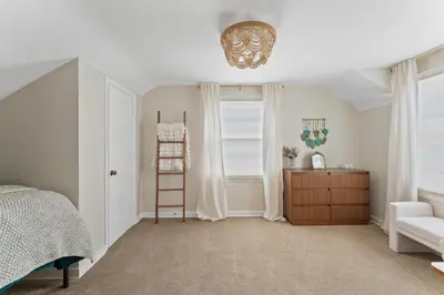 a bedroom with a ladder and a bed and a chair at Midtown Bungalow in Reno