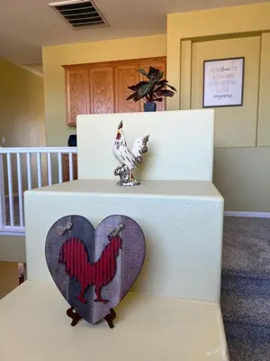 a cake with a heart and a chicken on top at Cozy room at la paz in Fresno