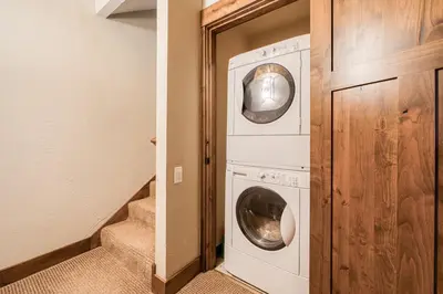 a laundry room with a washer and dryer at Northshore Lakeside Condo 15 by Tahoe Getaways - Walk to Beach with HOA in Tahoe City