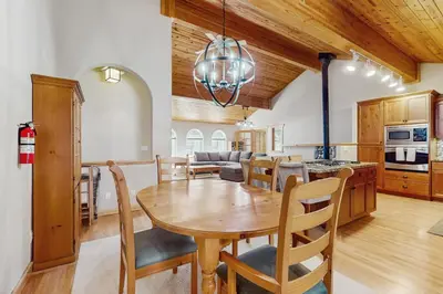 a kitchen and dining room with a wooden table and chairs at The Tahoe House in Truckee