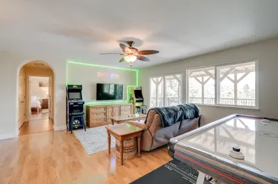 a living room with a ceiling fan and a pool table at Mtn Views and Game Room Family Retreat in Groveland in Groveland