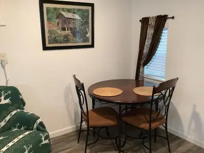 a dining room table and chairs in a room at Shady Creekside Cabin in Miramonte