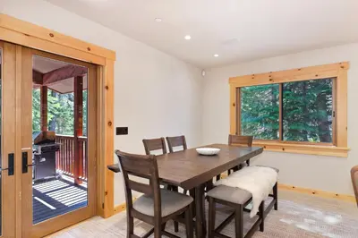 a dining room with a table and chairs and a balcony at Big Chief River Retreat-Located on Truckee River in Truckee