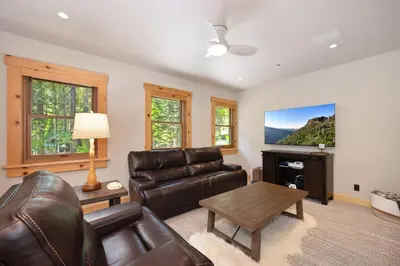 a living room with a couch and a table at Big Chief River Retreat-Located on Truckee River in Truckee