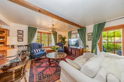 a living room with a white couch and a table at Vintage Sunset Villa by Bass Lake 17 miles from Yosemite National Park in Oakhurst