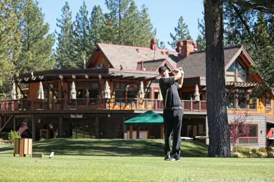 a man swinging a baseball bat in front of a house at Wintergreen at Tahoe Donner by Tahoe Getaways - 3BR w HOA! in Truckee