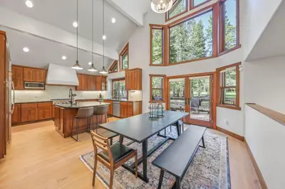 a kitchen with a table and chairs and windows at Wintergreen at Tahoe Donner by Tahoe Getaways - 3BR w HOA! in Truckee