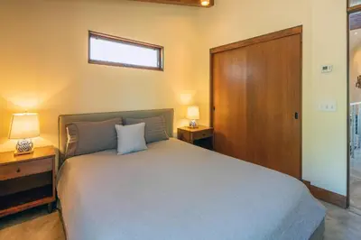 a bedroom with a large bed with two night stands and a window at Beautiful View By Hauserman Rentals in Tahoe City