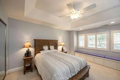 a bedroom with a bed and a ceiling fan at Hemlock Hacienda in Groveland