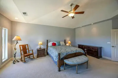 a bedroom with a bed and a ceiling fan at Hemlock Hacienda in Groveland