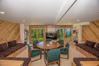 a living room with a wooden table and chairs at Big Pine By Hauserman Rentals in Tahoe City