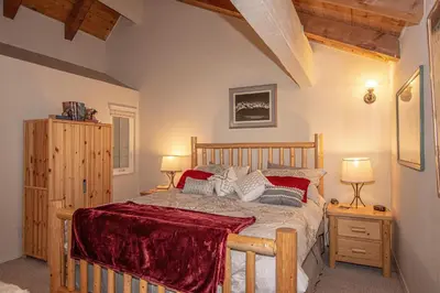 a bedroom with a wooden bed and two lamps at Carnelian Woods # 11 By Hauserman Rentals in Carnelian Bay
