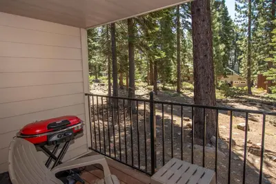 a screened in porch with a grill and a chair at Carnelian Woods # 11 By Hauserman Rentals in Carnelian Bay