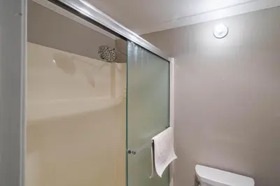 a bathroom with a glass shower with a toilet at NorthShore # 47 By Hauserman Rentals in Tahoe City