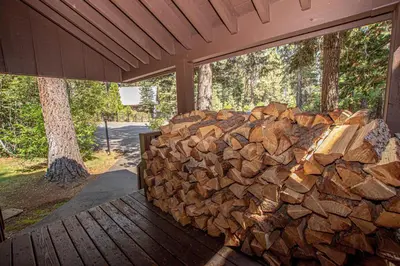 a pile of fire wood sitting on a porch at NorthShore # 47 By Hauserman Rentals in Tahoe City