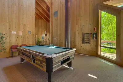 a pool table in a room with wooden walls at Carnelian Woods #128 By Hauserman Rentals in Carnelian Bay