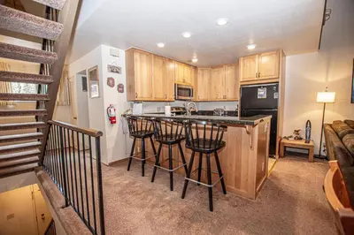 a kitchen with bar stools and a counter top at Carnelian Woods #128 By Hauserman Rentals in Carnelian Bay
