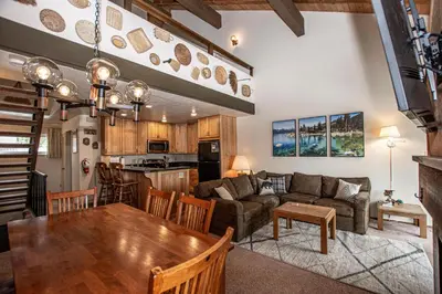 a kitchen and living room with a table and a couch at Carnelian Woods #128 By Hauserman Rentals in Carnelian Bay
