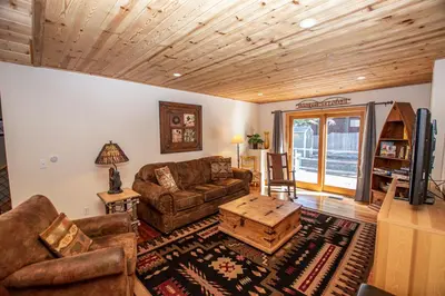 a living room with a couch and a table at Bonanza By Hauserman Rentals in Tahoe City