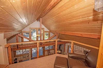 a living room with a couch in a cabin at Bonanza By Hauserman Rentals in Tahoe City