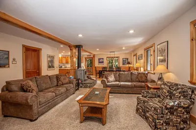 a living room with couches and a table at Celtic Lodge By Hauserman Rentals in Homewood