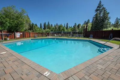 a large swimming pool with blue water in a yard at Star Harbor # 10 By Hauserman Rentals in Tahoe City