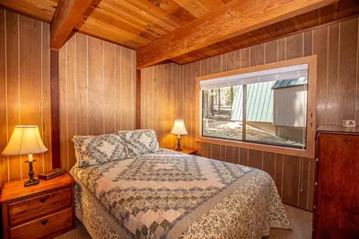 a bedroom with a bed and a window at Das Berghaus By Hauserman Rentals in Tahoe City