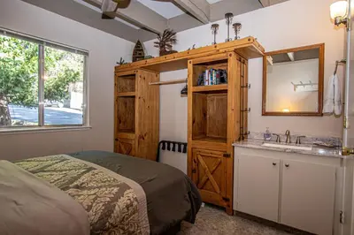 a bedroom with a bed and a sink and a mirror at Dollar Hill II # 49 By Hauserman Rentals in Tahoe City