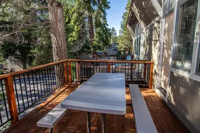 a wooden deck with a bench on a balcony at Dollar Hill II # 49 By Hauserman Rentals in Tahoe City