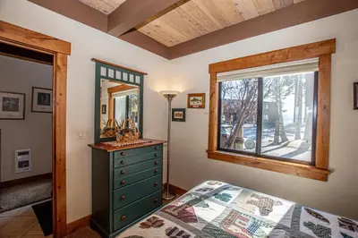 a bedroom with a green dresser and a mirror at Star Harbor # 27 By Hauserman Rentals in Tahoe City