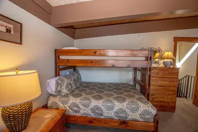 a bedroom with a bunk bed and a lamp at Star Harbor # 27 By Hauserman Rentals in Tahoe City