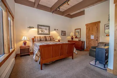 a bedroom with a bed and a desk and a chair at Star Harbor # 27 By Hauserman Rentals in Tahoe City