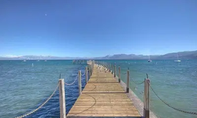 a wooden pier in the middle of the water at Star Harbor # 27 By Hauserman Rentals in Tahoe City