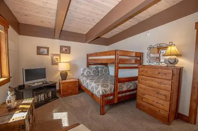 a bedroom with a bunk bed and a television at Star Harbor # 27 By Hauserman Rentals in Tahoe City