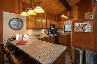 a kitchen with wooden cabinets and a counter top at Grainger By Hauserman Rentals in Tahoe City