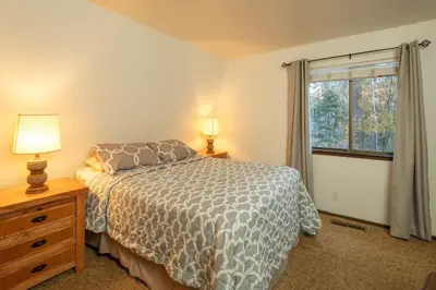 a bedroom with a bed and a window at Grainger By Hauserman Rentals in Tahoe City