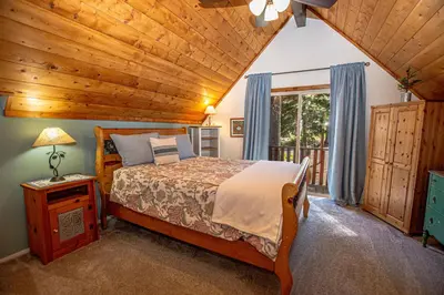 a bedroom with a bed and a wooden ceiling at Alpine Welcome By Hauserman Rentals in Tahoe City