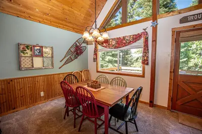 a dining room with a wooden table and chairs at Alpine Welcome By Hauserman Rentals in Tahoe City